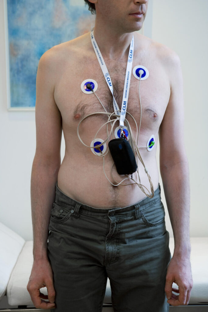 Man wearing traditional holter monitor.